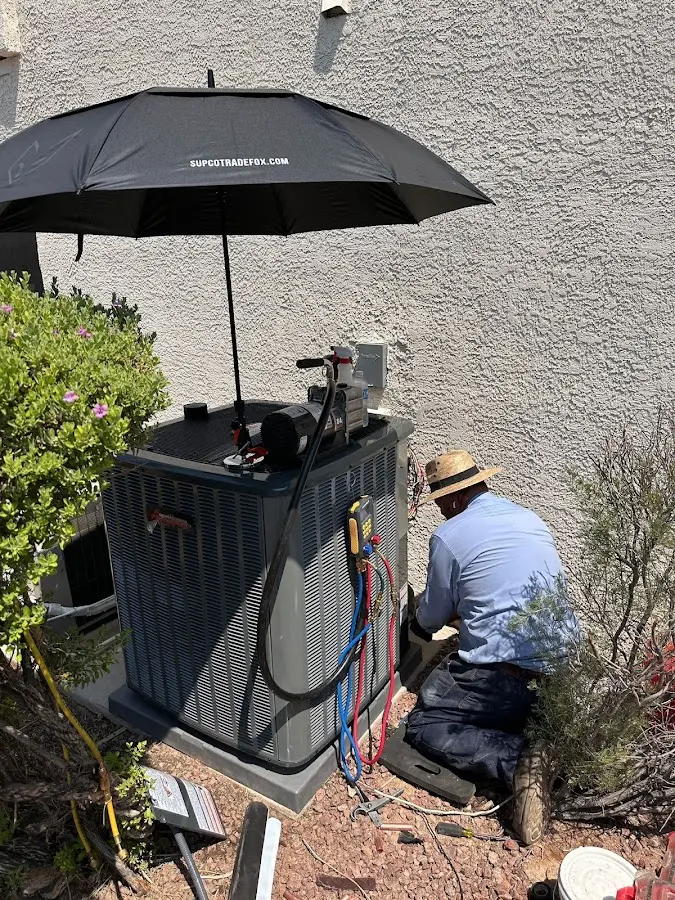 HVAC technician performing outdoor AC maintenance in Galveston